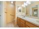 Bathroom with double sinks, wood cabinets, and accessible features, offering comfort and convenience at 9093 Sw 91St Cir, Ocala, FL 34481