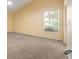 Spacious bedroom with a window, fan and neutral carpet, offering a comfortable and airy feel at 9093 Sw 91St Cir, Ocala, FL 34481