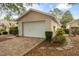 A one-story home with a brick driveway and a two-car garage, all surrounded by well-maintained landscaping at 9093 Sw 91St Cir, Ocala, FL 34481