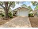 Charming single-story home with a well-manicured lawn and a brick-paved driveway at 9093 Sw 91St Cir, Ocala, FL 34481