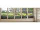 Enclosed sunroom with expansive windows offers panoramic views of the lush green landscape at 9093 Sw 91St Cir, Ocala, FL 34481