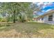 Spacious backyard with mature trees creating a serene and private outdoor space at 9859 Sw 45Th Ave, Ocala, FL 34476