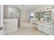 Spacious bathroom with a glass shower, soaking tub, and vanity with sink at 9859 Sw 45Th Ave, Ocala, FL 34476