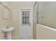 Bathroom features a single sink and standing shower with white tiled walls at 9859 Sw 45Th Ave, Ocala, FL 34476