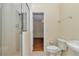Bathroom with step-in shower featuring clear glass doors and neutral tile at 9859 Sw 45Th Ave, Ocala, FL 34476