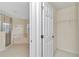 Bathroom featuring a glass shower, jacuzzi tub, and a doorway to a walk-in closet at 9859 Sw 45Th Ave, Ocala, FL 34476