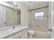 Bathroom with vanity and shower/tub combo featuring neutral tiling and fixtures at 9859 Sw 45Th Ave, Ocala, FL 34476