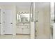 Well-lit bathroom features a glass shower, spacious vanity with ample storage, and a door to the toilet room at 9859 Sw 45Th Ave, Ocala, FL 34476