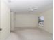Spacious bedroom featuring a ceiling fan and a window offering natural light at 9859 Sw 45Th Ave, Ocala, FL 34476