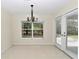 Dining area featuring natural light through a large window and sliding glass door at 9859 Sw 45Th Ave, Ocala, FL 34476