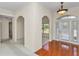 Elegant foyer featuring arched entryways, hardwood flooring, and neutral wall colors creating a welcoming atmosphere at 9859 Sw 45Th Ave, Ocala, FL 34476