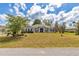 Charming one-story home featuring a manicured lawn and mature trees, offering great curb appeal at 9859 Sw 45Th Ave, Ocala, FL 34476