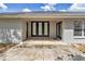 Covered patio featuring elegant black French doors offering seamless indoor-outdoor living at 9859 Sw 45Th Ave, Ocala, FL 34476