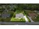 Aerial view of a beautiful home surrounded by lush greenery and a well-manicured lawn at 4966 Sw 107Th Loop, Ocala, FL 34476