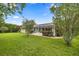 Picture of a sprawling backyard featuring lush greenery, mature trees and a screened-in lanai at 4966 Sw 107Th Loop, Ocala, FL 34476