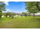 Spacious backyard with well-maintained lawn and a screened-in lanai for outdoor enjoyment at 4966 Sw 107Th Loop, Ocala, FL 34476