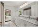 Bright bathroom with double vanity, and access to screened-in porch at 4966 Sw 107Th Loop, Ocala, FL 34476