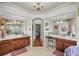 Bathroom with dual sinks, a chandelier, and a view of the shower and main bedroom at 4966 Sw 107Th Loop, Ocala, FL 34476