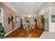Spacious dining room with hardwood floors, elegant chandelier, and ample natural light, ideal for Gathering gatherings at 4966 Sw 107Th Loop, Ocala, FL 34476