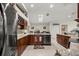 Modern kitchen with stainless steel appliances, granite countertops, and a skylight, perfect for culinary enthusiasts at 4966 Sw 107Th Loop, Ocala, FL 34476