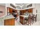 Well-equipped kitchen with granite countertops, wooden cabinetry, and modern appliances, ready for meal preparation at 4966 Sw 107Th Loop, Ocala, FL 34476