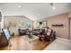 Spacious living room with comfortable seating, hardwood floors, and large windows, creating a welcoming atmosphere at 4966 Sw 107Th Loop, Ocala, FL 34476