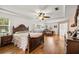 Spacious main bedroom features hardwood floors, a ceiling fan, and ample natural light at 4966 Sw 107Th Loop, Ocala, FL 34476