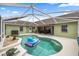 Screened-in pool area perfect for relaxing, with a lounge chair floating in the pool at 4966 Sw 107Th Loop, Ocala, FL 34476