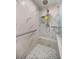 Modern shower features marble-style tile, a built-in bench, and sleek fixtures at 4966 Sw 107Th Loop, Ocala, FL 34476