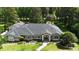 Sprawling home boasts mature trees, lush landscaping, and an inviting entryway leading to a comfortable home at 7939 Se 12Th Cir, Ocala, FL 34480