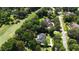 Birds-eye view showcasing a home surrounded by mature trees and a golf course, highlighting its desirable location at 7939 Se 12Th Cir, Ocala, FL 34480