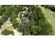 Aerial view of a house nestled among lush greenery and a golf course, offering a serene and private setting at 7939 Se 12Th Cir, Ocala, FL 34480