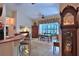 Cozy breakfast nook with a bar, tile flooring, and plenty of natural light streaming in through a large window at 7939 Se 12Th Cir, Ocala, FL 34480