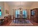 Formal dining area with hardwood floors, a chandelier, and classic furnishings for elegant dining at 7939 Se 12Th Cir, Ocala, FL 34480