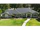 Beautiful single-story home with manicured landscaping, a curved walkway, and a charming exterior facade at 7939 Se 12Th Cir, Ocala, FL 34480