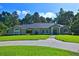 Charming single-story home with well-maintained lawn and lush landscaping creating a welcoming curb appeal at 7939 Se 12Th Cir, Ocala, FL 34480