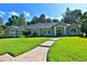 Inviting single-story home with well-manicured lawn and brick walkway leading to the front door at 7939 Se 12Th Cir, Ocala, FL 34480