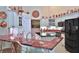 Bright kitchen boasts white cabinets, modern appliances, red marble countertops, and copper accents at 7939 Se 12Th Cir, Ocala, FL 34480
