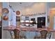 Bright kitchen boasts white cabinets, modern appliances, red marble countertops, and copper accents at 7939 Se 12Th Cir, Ocala, FL 34480