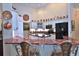 Bright kitchen boasts white cabinets, modern appliances, red marble countertops, and copper accents at 7939 Se 12Th Cir, Ocala, FL 34480