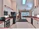 Bright kitchen with white cabinets, black appliances, marble countertops, and a center island at 7939 Se 12Th Cir, Ocala, FL 34480
