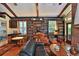 Warm living room featuring built-in bookshelves, a brick fireplace, and comfortable leather furniture at 7939 Se 12Th Cir, Ocala, FL 34480