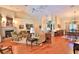 Spacious living room featuring a fireplace, hardwood floors, and vaulted ceilings with ceiling fan at 7939 Se 12Th Cir, Ocala, FL 34480