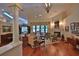 Bright living room with hardwood floors, fireplace, and expansive windows offering plenty of natural light at 7939 Se 12Th Cir, Ocala, FL 34480