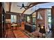 Elegant living room featuring a brick fireplace, hardwood floors, and extensive built-in bookshelves at 7939 Se 12Th Cir, Ocala, FL 34480