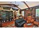 Inviting living room featuring floor-to-ceiling bookshelves and a vaulted ceiling with wooden beams at 7939 Se 12Th Cir, Ocala, FL 34480