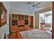 Spacious living room with a built-in cabinet, a ceiling fan, and a plush rug at 7939 Se 12Th Cir, Ocala, FL 34480