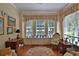 Cozy sun room featuring multiple windows with garden views and comfortable seating at 7939 Se 12Th Cir, Ocala, FL 34480