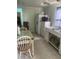 Modest kitchen featuring white appliances and tile flooring at 10805 Se 102Nd Pl, Ocala, FL 34472