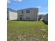 The backyard features a green lawn with solar panels on the roof, and a sliding glass door at 1114 Brimstone Cir, Winter Haven, FL 33884